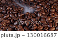 Close up of seeds of coffee. Fragrant coffee beans are roasted smoke comes from coffee beans. 130016687