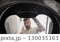 Handsome Man Opening Washing Machine Seen from Inside Drum 130035163