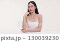 Skincare commercial video featuring a young Asian woman applying natural cosmetic cream in a soft, minimal studio setting. Ideal for promoting beauty, self-care, and organic skincare products. 130039230