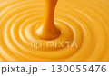 Slow motion swirl of melted caramel, glossy texture in macro close-up, copy space 130055476
