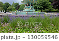 Camera tilts up from spring flowers to reveal Ross Fountain in Princes Street Gardens, Edinburgh. Shot on a summer day  130059546