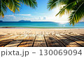 Empty wooden planks overlooking a beautiful tropical beach with palm trees. 130069094