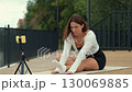 Yoga instructor streaming online class outdoors 130069885