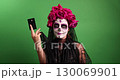 Woman Wears Sugar Skull Makeup for Day of the Dead Celebration 130069901
