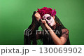 Woman in Calavera Catalina Makeup Holds Knife on Green Screen 130069902