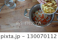 Chef adding chopped potatoes a pot containing sauteed onions and carrots, preparing ingredients a meal delicious video fullhd 130070112