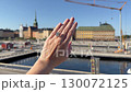 A landscape video showing a hand with an oval diamond engagement ring or wedding band shining in sunlight against Scandinavia skyline by the waterfront. 130072125