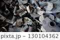 Close-up of a pile of rusty metal parts with signs of wear. 130104362