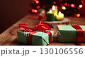 Wrapped Christmas Presents on Wooden Table With Burning Candles 130106556