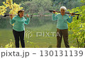 Elderly women fitness with Nordic poles outdoors 130131139