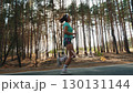 Woman jogging in forest outdoors 130131144