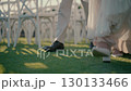 Bride and groom walking in garden on wedding ceremony, close-up of legs. 130133466