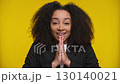 Smiling woman making a hopeful wish gesture 130140021