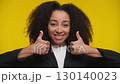 Happy woman giving double thumbs up gesture 130140023
