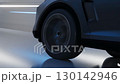 Close-up of the wheels of a modern SUV driving fast through a lighted tunnel. Dynamic strobe lights emphasize the sense of speed and technology. 130142946