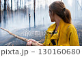 Female lifeguard in uniform holding a rescue pole, tense expression. A dramatic scene of emergency aid and determination. Generative AI. 130160680