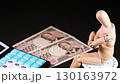 旋轉木偶、計算器和兩張 10,000 日元鈔票 130163972
