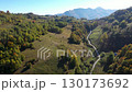 Aerial view of mountain dust road and alpine village in autumn by drone 130173692