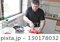 Chef dicing red peppers in kitchen 130178032
