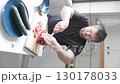 Chef cutting red bell pepper on wooden board 130178033