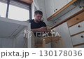 Man peeling apple in kitchen montage 130178036