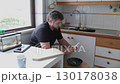 Man peeling potatoes in domestic kitchen 130178038