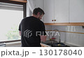Man preparing food in kitchen 130178040