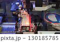 Robotic, automatic, high-tech equipment, machine at factory for production of LED lamps, LED panels. Close-up of process of installing LEDs on panel. Technological process of producing LED strips. 130185785