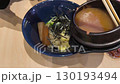 a bowl of delicious Korean-style instant noodles, pouring the hot soup over the toppings and then using chopsticks to show the delicious-looking noodles. 130193494