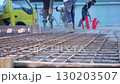 Pouring mixed concrete after installing steel reinforcement to create a house.  130203507