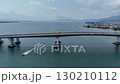 Drone aerial photography: A motorboat passing under Lake Biwa Bridge under a summer sky 130210112