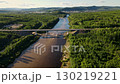 Exploring a winding river and bridge surrounded by lush green landscape 130219221