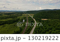 Scenic landscape with winding road and railway near mountains in summer 130219222