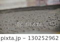 Fresh concrete pouring into container at construction site 130252962