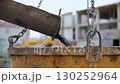 Concrete pouring into yellow bucket at construction site 130252964