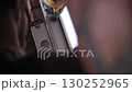 Worker installing window frame with electric drill on construction site 130252965