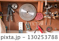 A set of carpentry tools arranged on a pegboard in a workshop, ready for a DIY project. 130253788