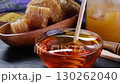 Honey stick and bowl of pouring honey, Close-up in 4K, UHD 130262040