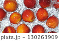 Dynamic Water Splash with Whole Peaches, Slow Motion Top View 130263909