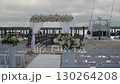 A Serene Beach Wedding Setup with Elegant Decor Elements and a Beautiful Scenic Backdrop 130264208