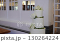 An Elegant Wedding Cake Adorned with Beautiful Floral Arrangements for a Special Day 130264224