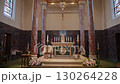 An Elegant Church Interior featuring Beautiful Wooden Beams along with Colorful Stained Glass 130264228