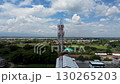 Aerial drone shot of 4G 5G communication tower over green landscape, Drone view of cellular network antenna and modern telecommunication tower, High resolution aerial footage of internet signal tower 130265203
