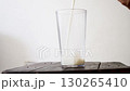 Glass filling with different types of milk, soy, almond, cow, lactose free, whole and skim 130265410