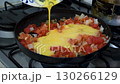 Cooking Colombian Scrambled Eggs, Making Huevos Pericos with Tomato and Onion, Preparing Traditional Scrambled Eggs in Pan 130266129