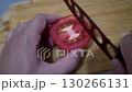 Cutting Tomato on Wooden Board, Fresh Tomato Being Chopped, Kitchen Preparation with Tomato 130266131