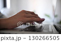 Female hand typing on laptop keyboard side view at home 130266505