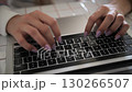 Woman fingers with manicure typing on laptop keyboard close up view 130266507