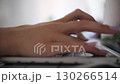 woman hand typing on laptop keyboard at home office side view 130266514