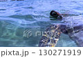 A sea turtle swimming leisurely on the beach of Miyakojima, Okinawa, emerges from the water (B) [Underwater photography] 130271919
